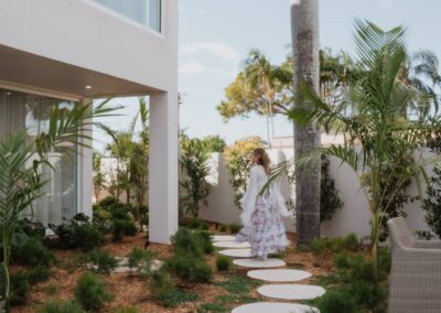 Young woman walking across curved garden steppers in a mulched landscape