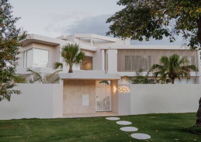 Modern front façade of Project SOL featuring clean architectural lines and natural finishes