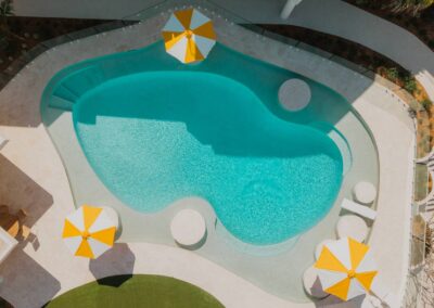 Aerial view of a glamorous pool area styled in Slim Aarons’ Hollywood-inspired aesthetic
